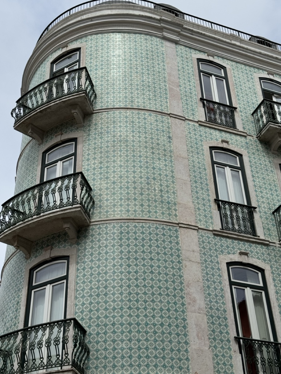 Building with green tiles and a rounded end